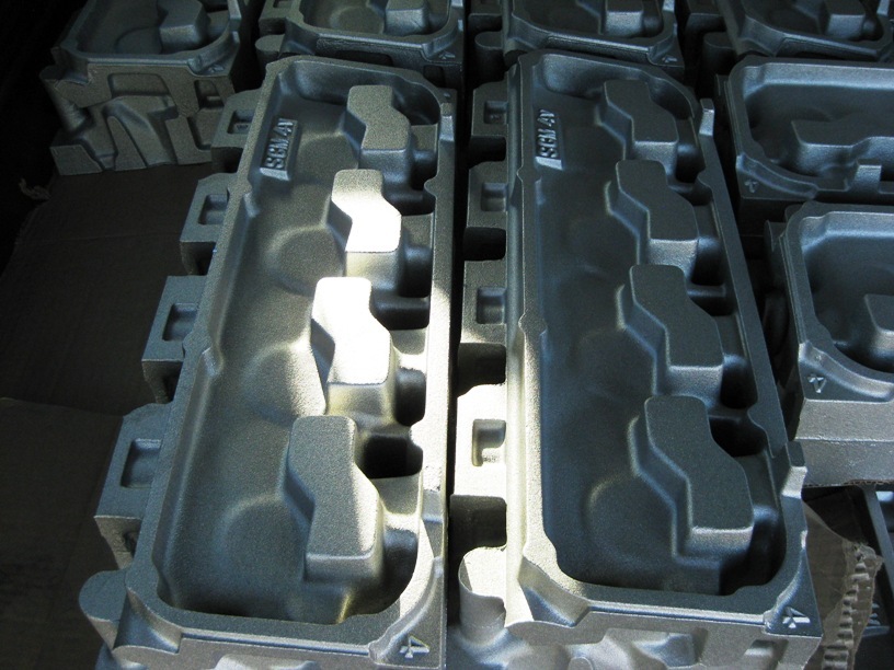 Stacked engine intake manifolds, some with markings like 'SEM 4V'