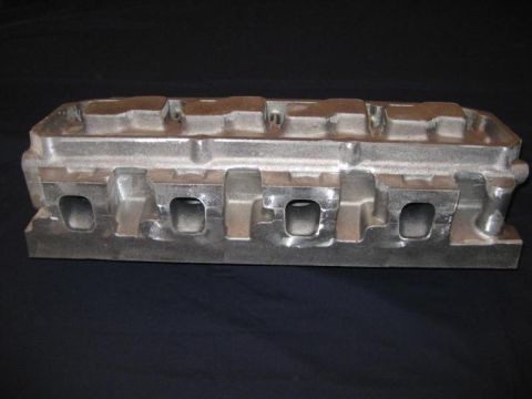 1972 Ford Ranchero - An aluminum engine intake manifold is shown against a dark backdrop.