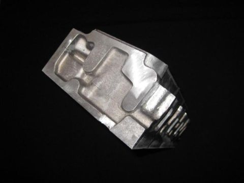 1972 Ford Ranchero - Close-up of an aluminum engine component with complex internal shapes.