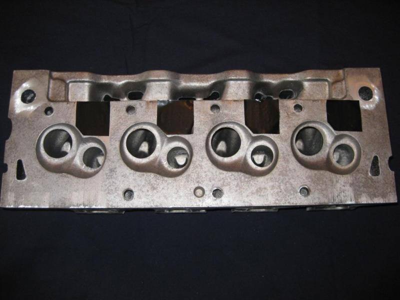 Engine cylinder head with four intake ports visible