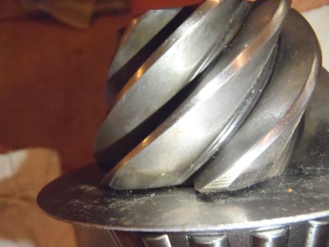 1990 Ford Bronco - This image shows a close-up view of a metal gear with spiral teeth, possibly a differential component.