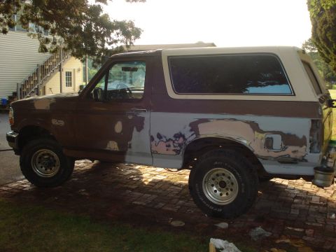 1993 Ford Bronco - Ford Bronco in the process of body repair, showing primer and filler on the side panels.
