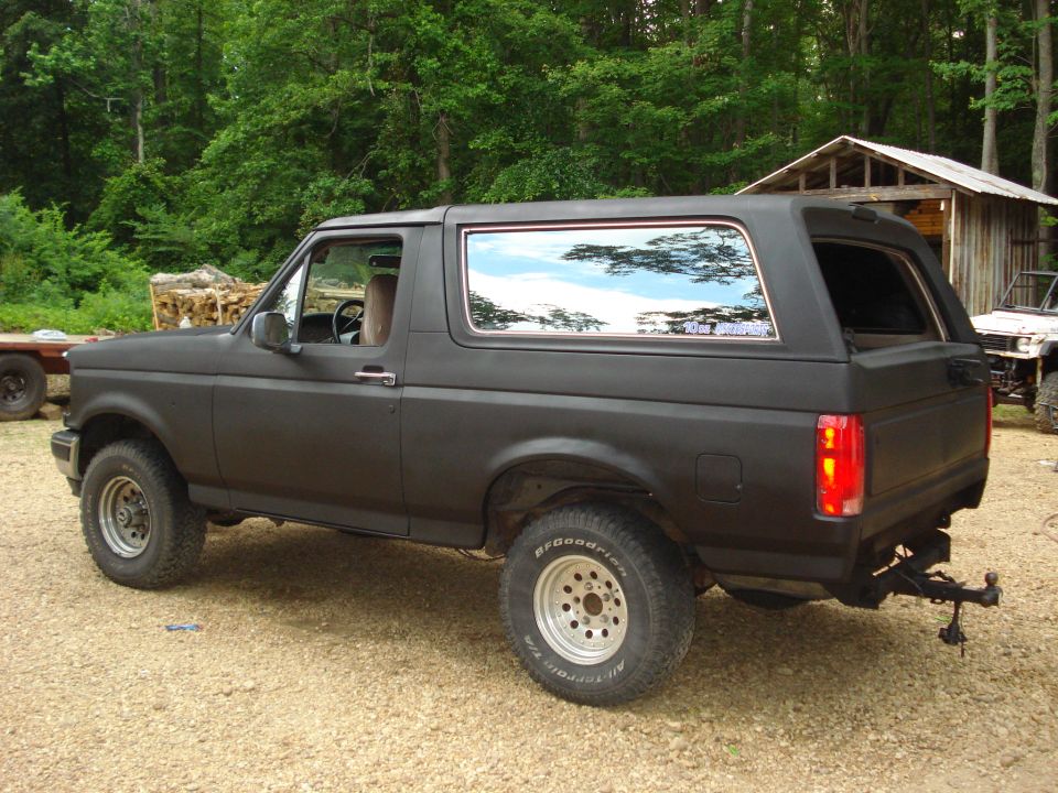 Black 1993 Ford Bronco side view with aftermarket wheels