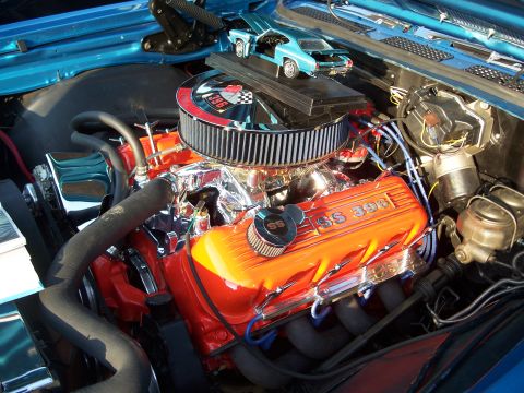 1971 Ford Ranchero - A detailed view of a car's engine bay, a model car placed on the air cleaner assembly.