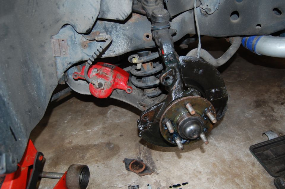 Red brake caliper and suspension assembly with Supermotors.net logo