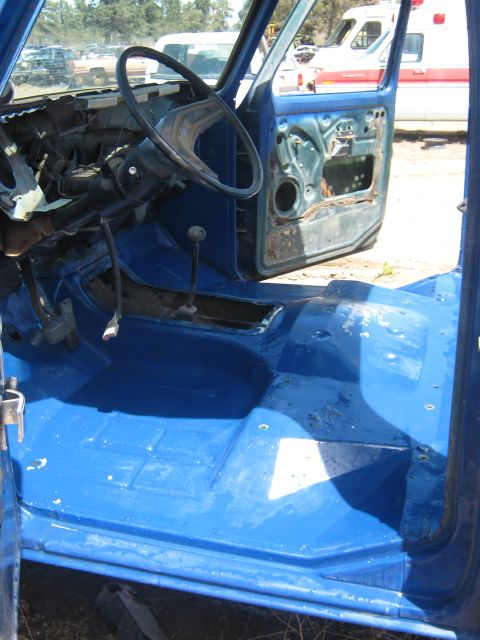 1978 Ford Bronco - The interior of a vehicle is shown with the doors removed and the dashboard exposed.