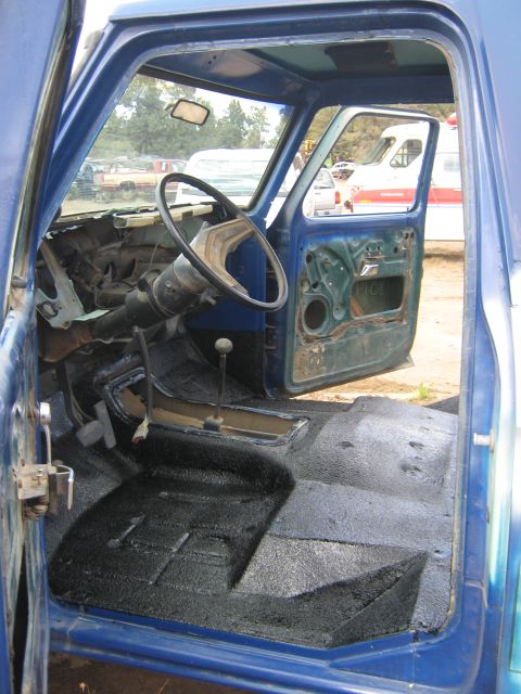 1978 Ford Bronco - Interior view of a blue pickup truck, showing the dashboard, steering wheel, and floor.