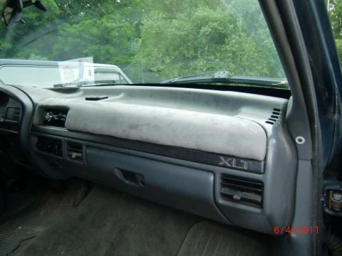 1993 Ford Bronco - Interior view of a vehicle dashboard with XLT badging, showing the dash cover and air vents.