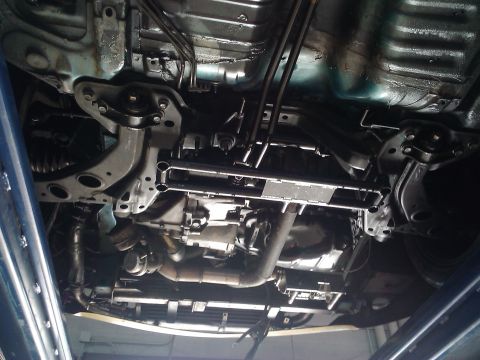 1995 Ford Probe - Underside view of a car's transmission and exhaust system, showing various mechanical components.