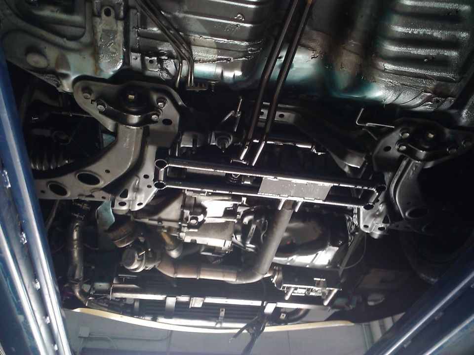 Underside view of car transmission and exhaust system