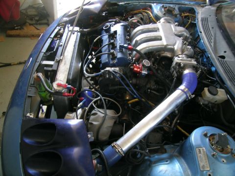 1995 Ford Probe - Close-up view of a modified engine bay, showing various aftermarket parts and custom modifications.