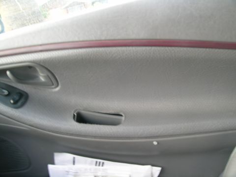 1995 Ford Probe - Close-up of a car's interior door panel, showing the handle and window controls.