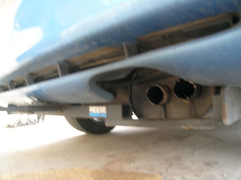 1995 Ford Probe - Underside view of a blue vehicle's rear, showing dual exhaust pipes and a Reese trailer hitch.