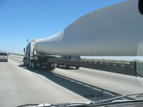1993 Ford Taurus - Oversized load carrying a wind turbine blade on a highway.