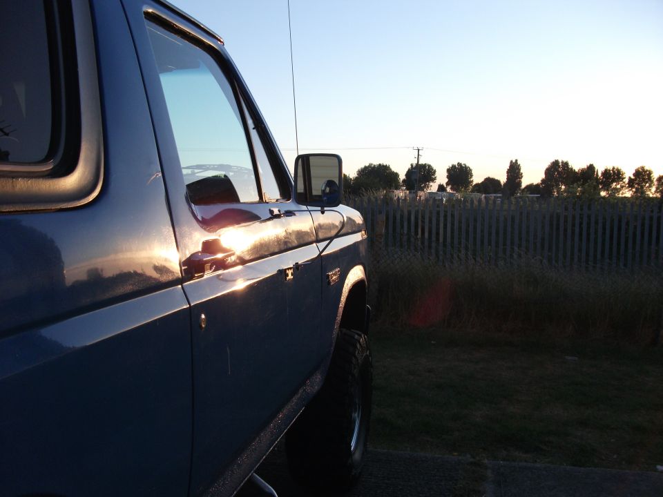 Blue 1982 Ford Bronco side view at sunset