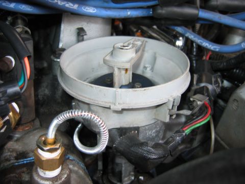 1992 Ford Bronco - Close-up of a Ford distributor cap and rotor assembly, showing spark plug wires.