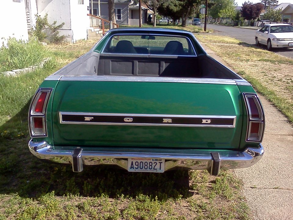 Green 1973 Ford Ranchero rear view with chrome bumper and Ford badging