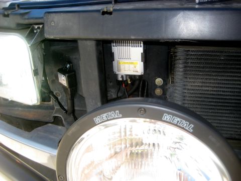 1996 Ford Bronco - Aftermarket lighting components are visible near the headlight assembly of a vehicle.