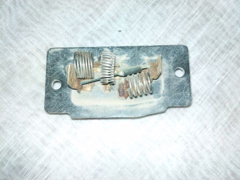 1998 Ford Crown Victoria - This blower motor resistor assembly shows signs of wear and dust accumulation on its components.