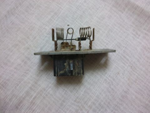 1998 Ford Crown Victoria - A blower motor resistor, a car part, is shown against a textured background.