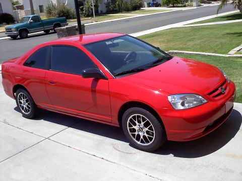 2003 Honda Civic - A red 2003 Honda Civic coupe is parked in a driveway, with a green pickup truck visible in the background.