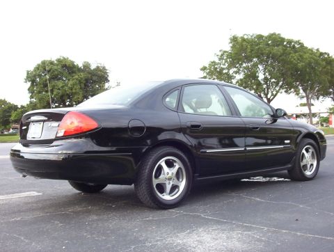2003 Ford Taurus - Black 2003 Ford Taurus sedan parked outdoors, showing its rear and side profile.