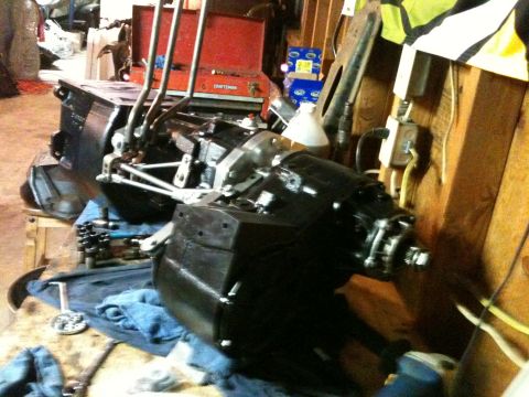 1976 Ford F-100 - A close-up view of a vehicle's transmission assembly, likely undergoing maintenance or repair in a garage setting.
