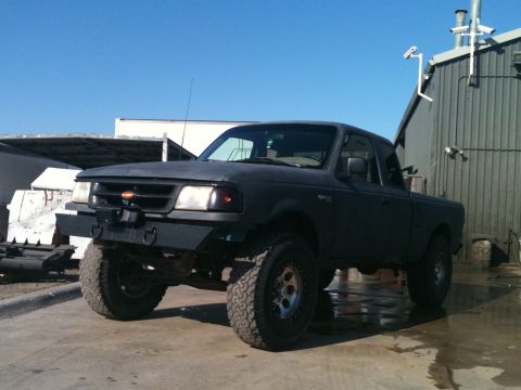 1996 Ford Ranger - This modified 1996 Ford Ranger pickup features an aggressive aftermarket bumper and lifted suspension, giving it a appearance.