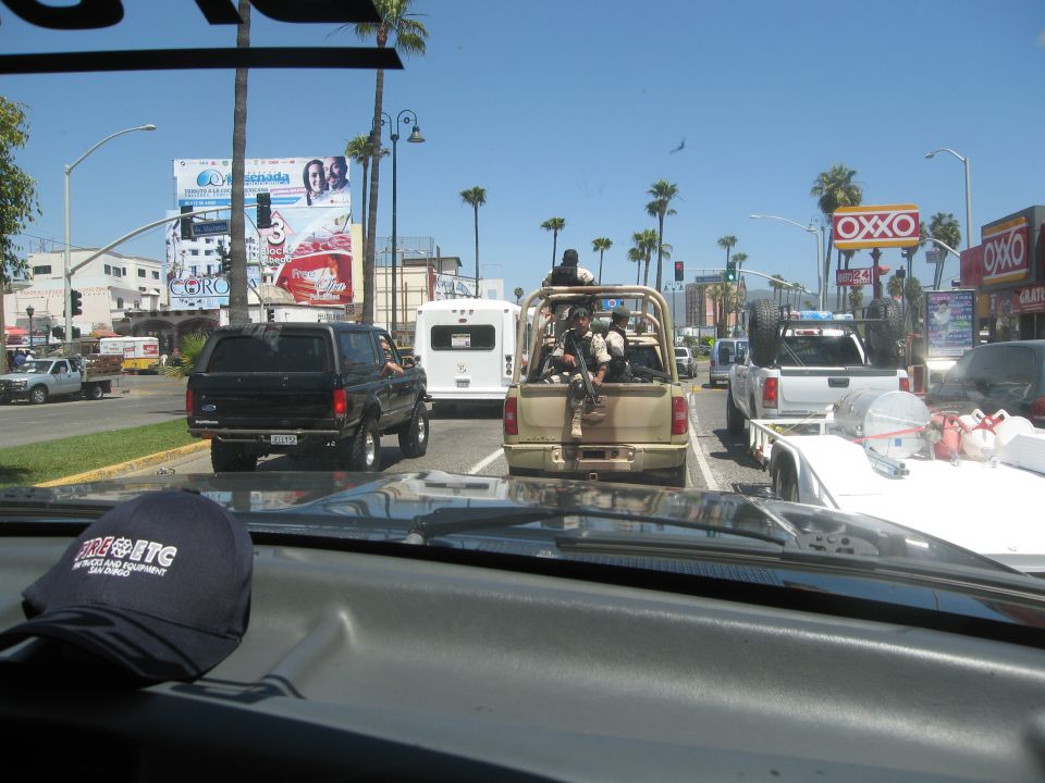 Black SUV from rear, aftermarket wheels, tinted windows, driving in traffic