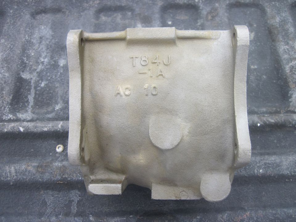 Metal casting part with text T84J -1A AC 10