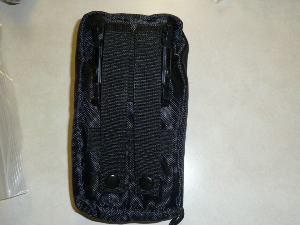 Black tactical pouch with two black clips on the back and two black snaps