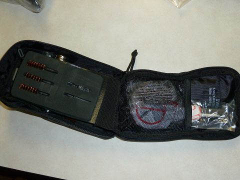 1992 Ford Mustang - A gun cleaning kit is shown inside a black zippered pouch with various tools and accessories.