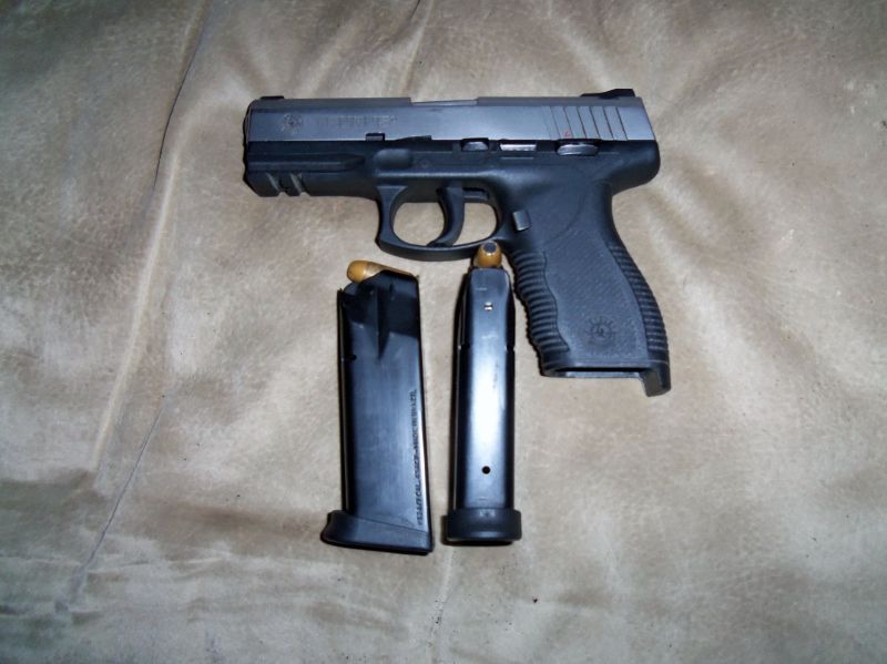 Pistol with two magazines, one loaded with a bullet