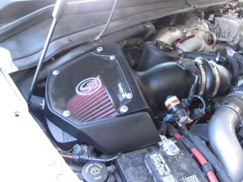 2008 Ford F-250 - Close-up view of an engine bay, focusing on the air intake system and battery.