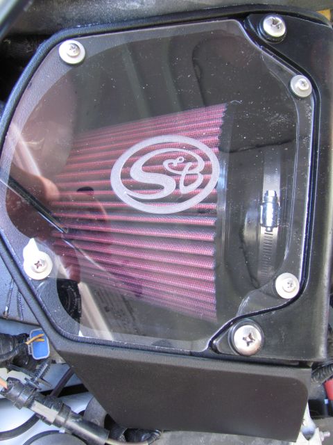 2008 Ford F-250 - Close-up of an S&B air intake system, a red filter and clear cover with the S&B logo.