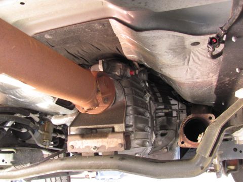 2008 Ford F-250 - Underside view of drivetrain components including driveshaft and transmission housing.