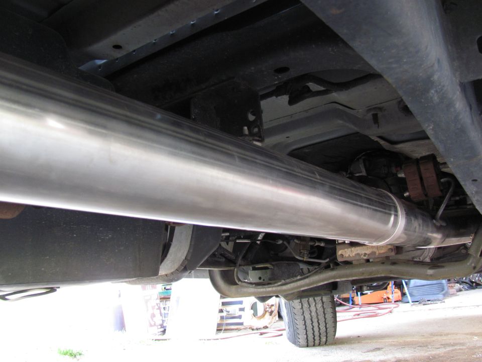 Underbody view of a large exhaust pipe on a truck
