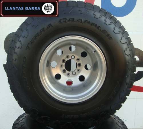 Tire with "TERRA GRAPPLER" text and a silver 5-lug wheel