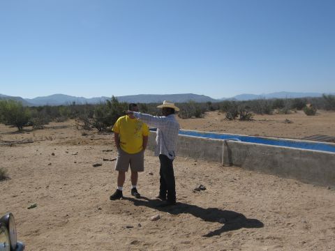 1986 Ford Bronco - Two men are in a desert landscape, one pointing towards the distance.