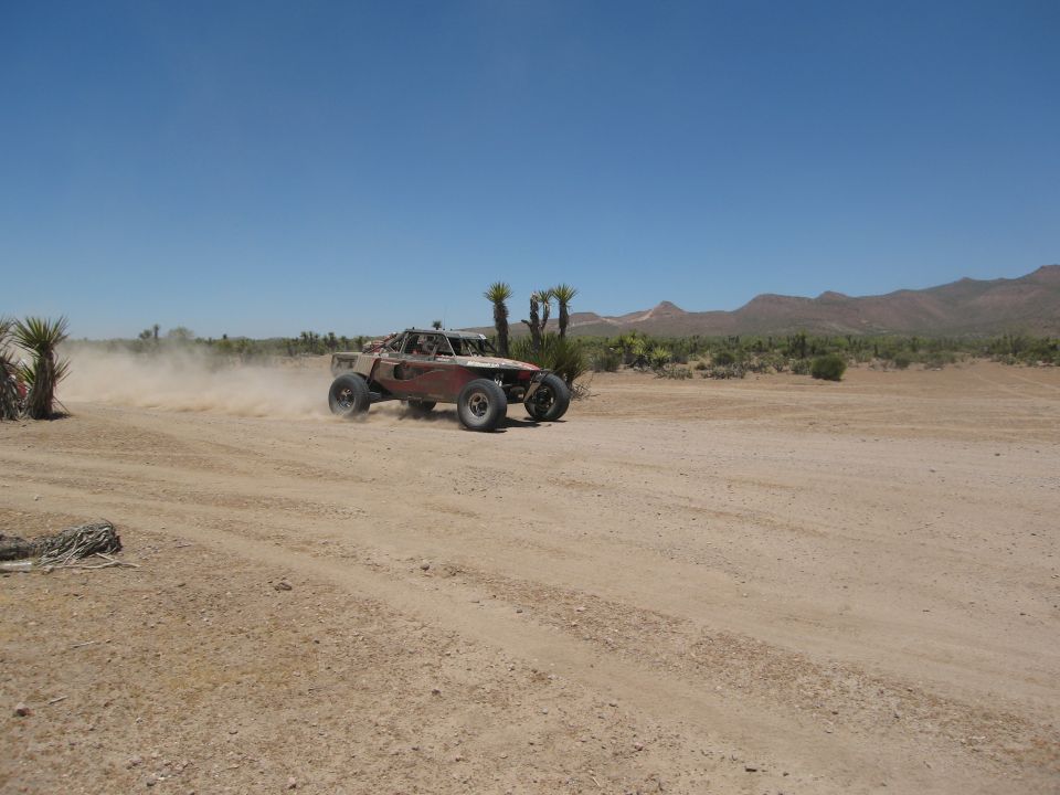 Off-road buggy in desert kicking up dust