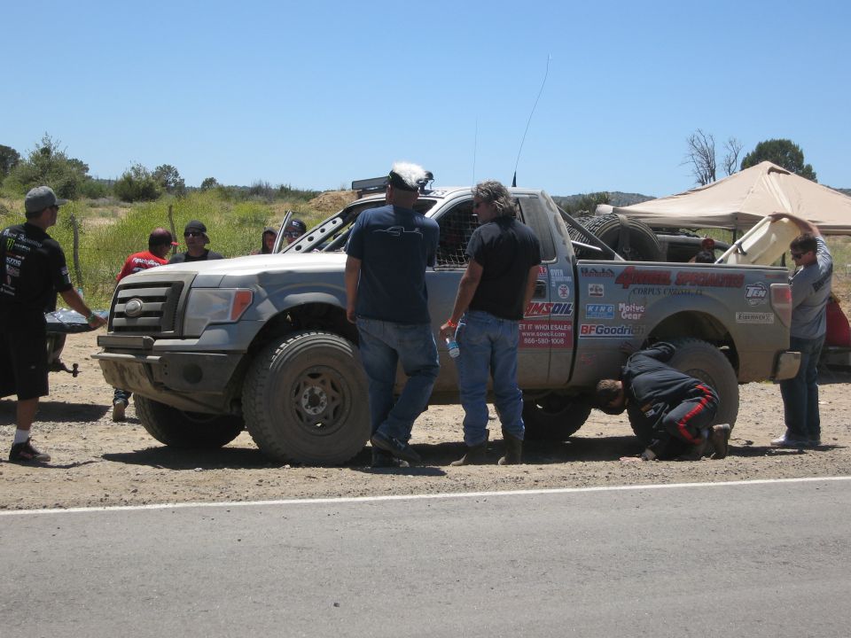Off-road pickup truck with racing decals, front 3/4 view