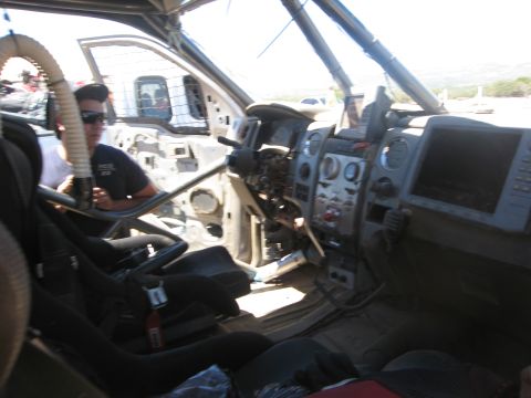 1986 Ford Bronco - The interior of a heavily modified truck is shown, stripped down for off-road use.