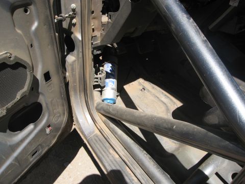 1986 Ford Bronco - A blue canister is visible inside the vehicle, near the door frame and roll cage.