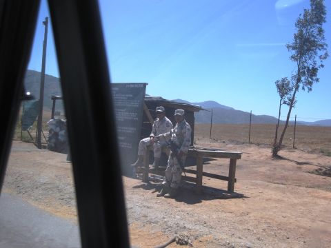 1986 Ford Bronco - Soldiers are stationed at a remote checkpoint under a clear blue sky.