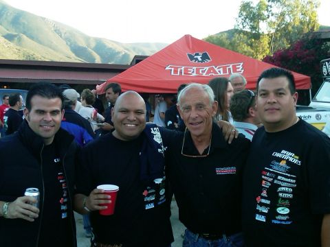 1986 Ford Bronco - A group of men pose for a photo outdoors, with a large red tent and mountains visible.