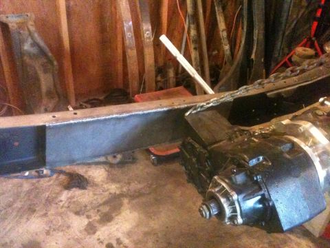 1976 Ford F-100 - Close-up of a truck frame and transmission assembly, likely undergoing restoration or modification.