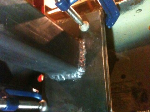 1976 Ford F-100 - Close-up of a metal frame being welded, secured by a blue clamp.