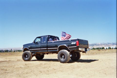 1992 Ford F-250 - Lifted 1992 Ford F-250 pickup truck flies the American flag.