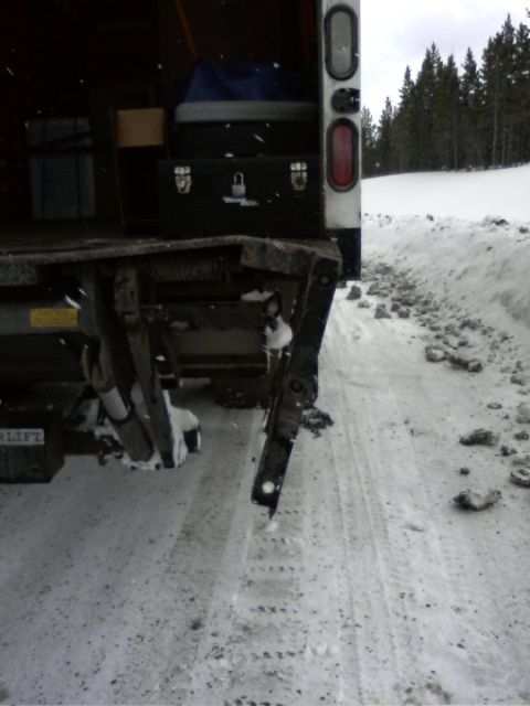 2006 Ford E350 - Utility truck with liftgate in snowy conditions.