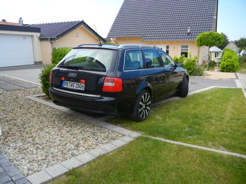 2003 Audi A6 - The rear of a black Audi A6 Avant is visible, showing its license plate and distinctive taillights.